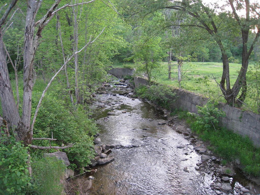 Old Hill Village - South End 445.jpg - In February 1937, residents of Hill Village NH learned that their village, near the Pemigewasset River, was to become a flood control reservoir for the Franklin Falls dam project. To accommodate the construction of the Franklin Falls Dam, the village of Hill NH was to be relocated. By January of 1940, the citizens of Hill NH formed an association, purchased land, and began planning a new model village with the help of the NH State Planning and Development Commission. Construction started in 1940, and by June of 1941 the new town hall and school were completed, along with the streets, water system, and 30 houses. The 1941 town meeting was called to order in the old town hall, recessed, and reconvened in the new village.